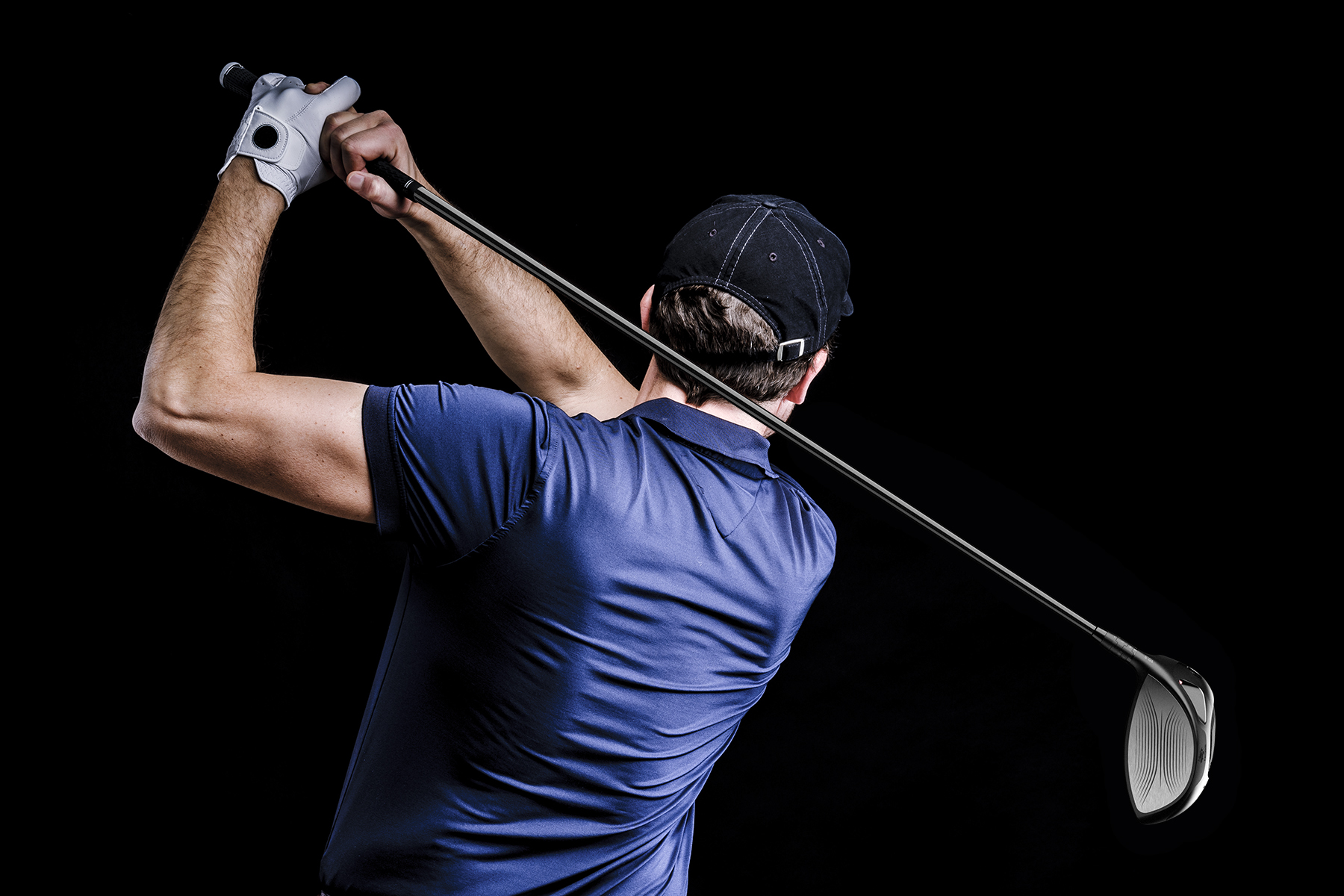 Close-up of a golf player intent on perfecting the swing